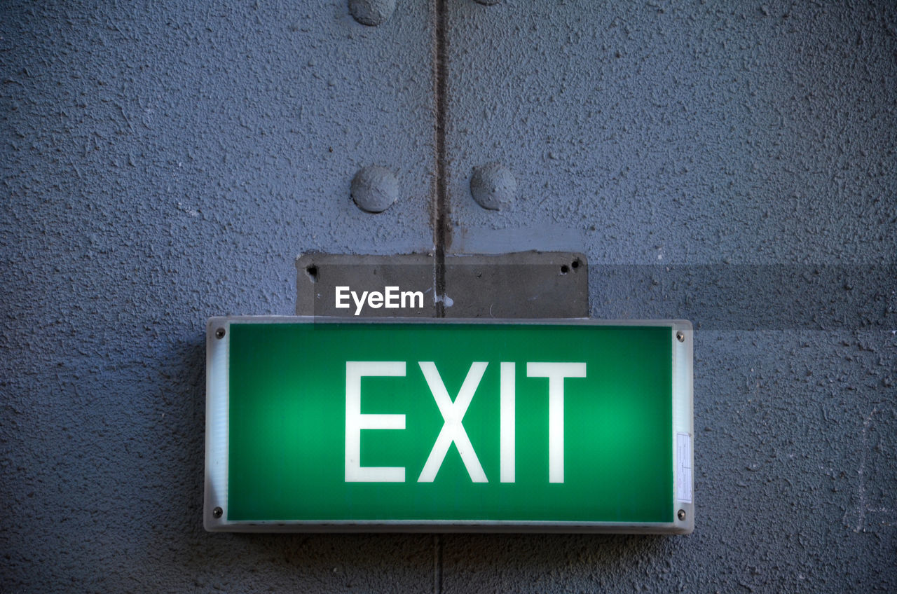 Illuminated exit sign on wall