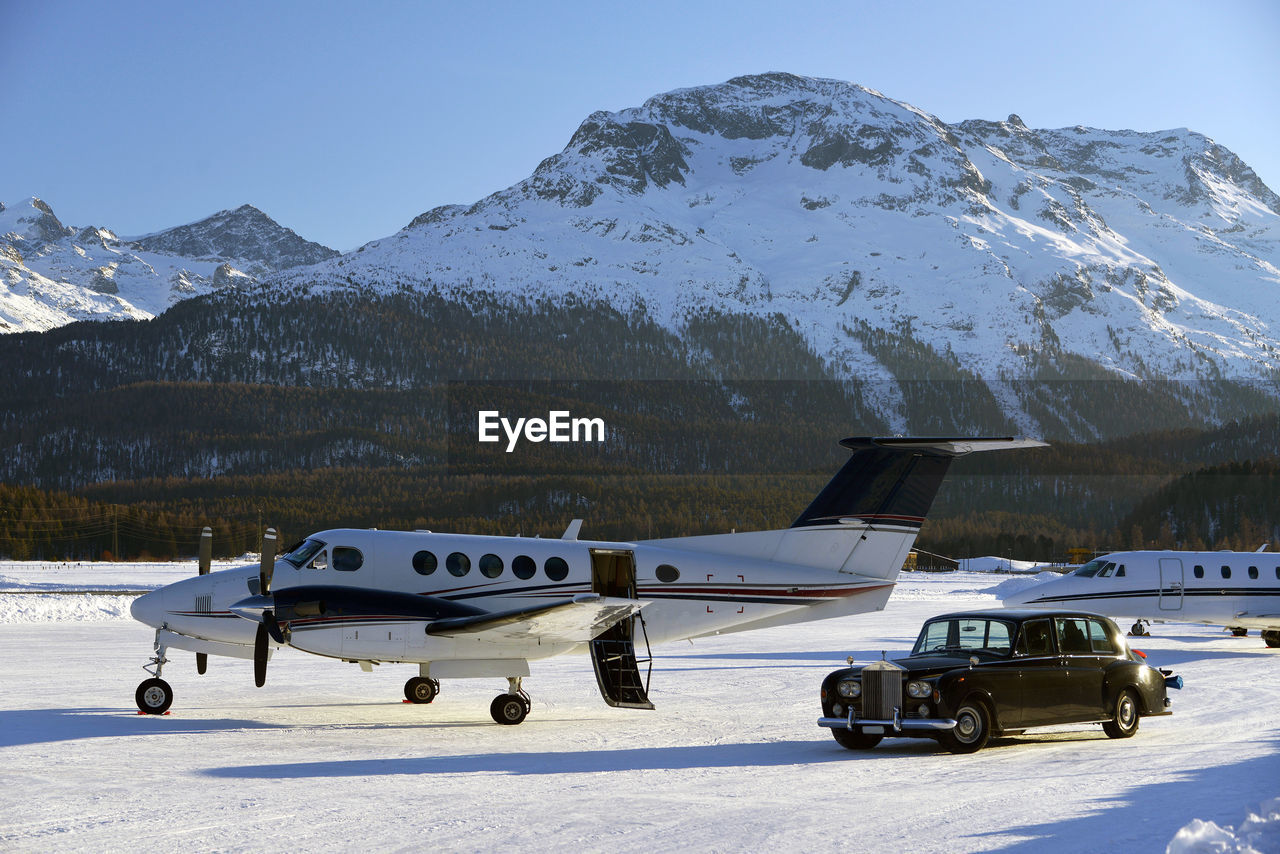 A vintage car and private jets in the airport of engadine st moritz
