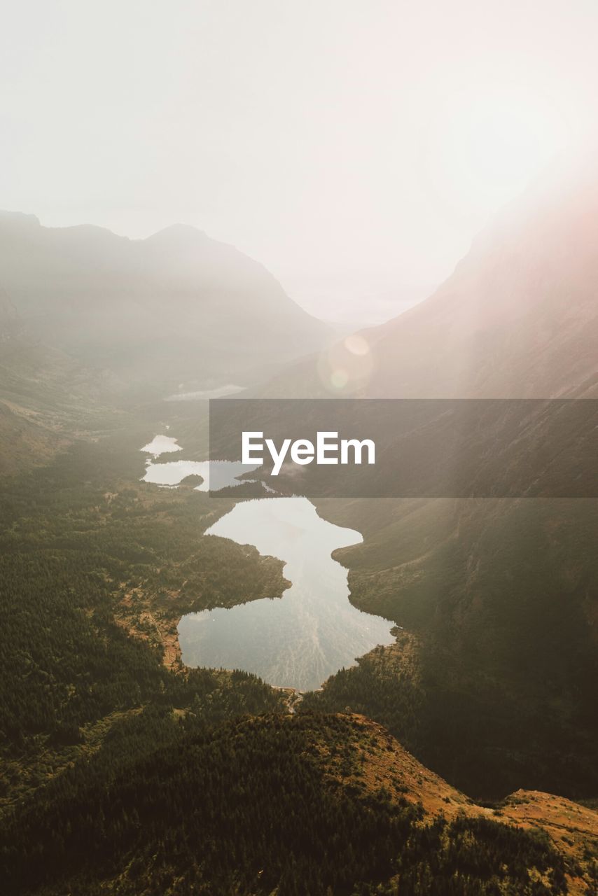 High angle view of lakes amidst mountains during sunny day