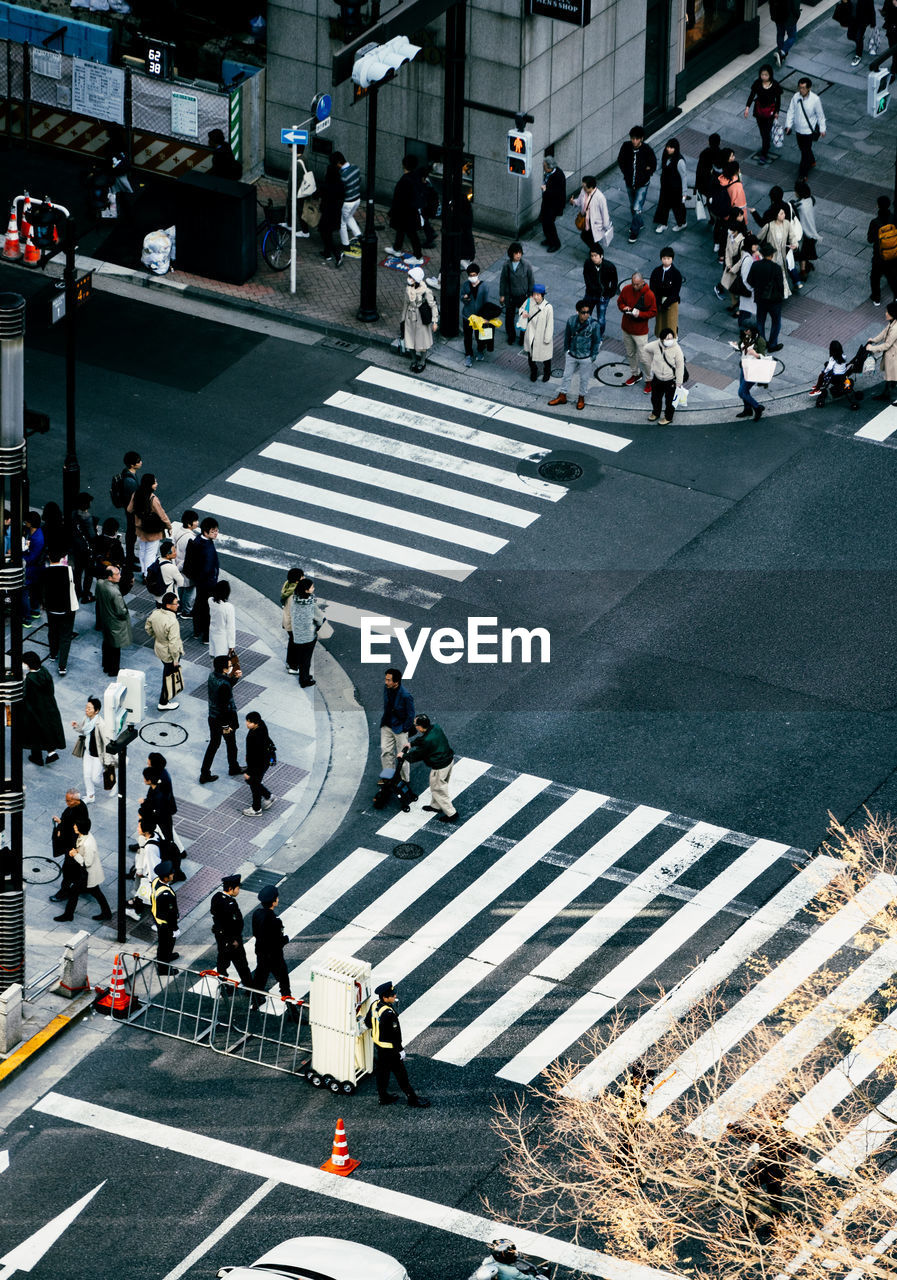 High angle view of people walking on city street