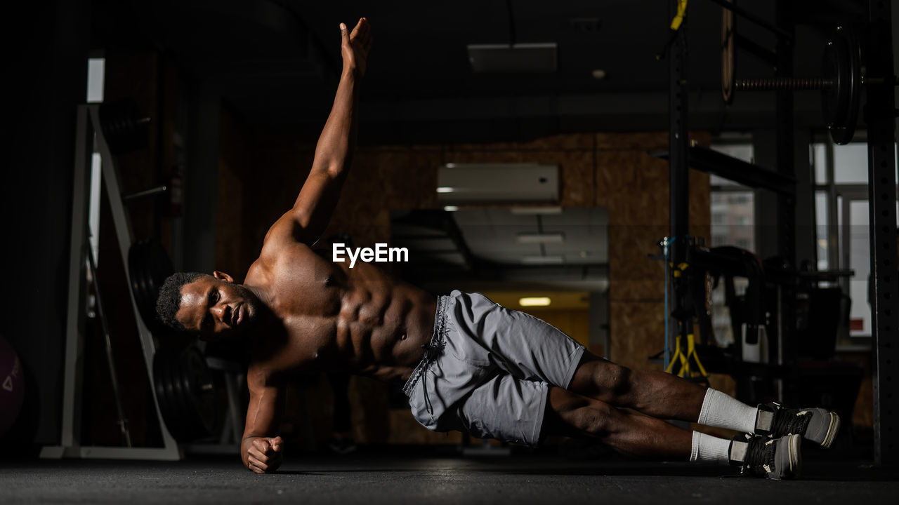 side view of young woman exercising in gym