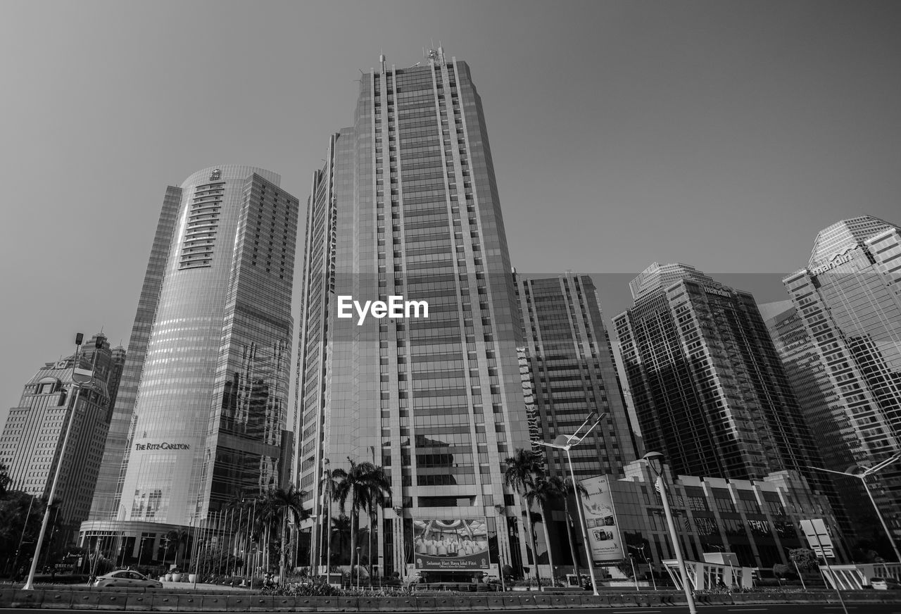 LOW ANGLE VIEW OF MODERN BUILDINGS AGAINST SKY