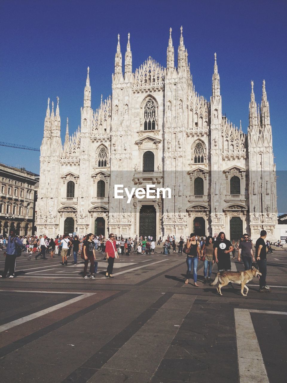 GROUP OF PEOPLE IN FRONT OF BUILDINGS