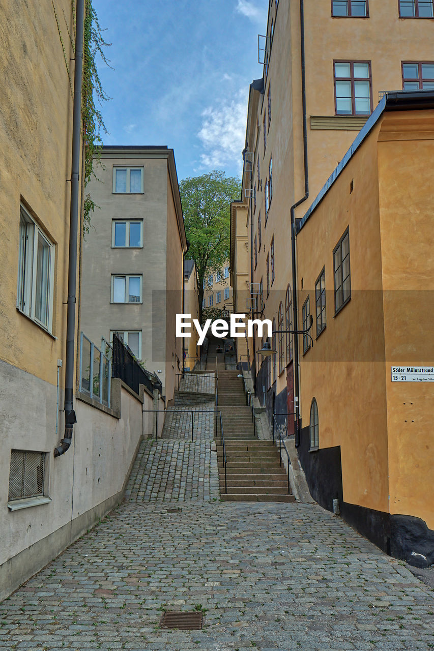 EMPTY ALLEY AMIDST BUILDINGS