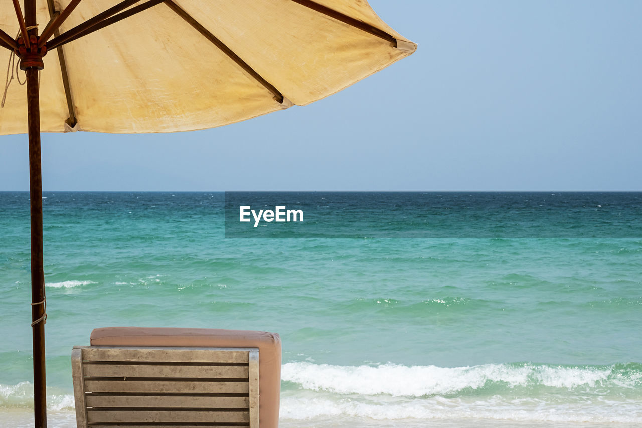 Sun lounger and beach umbrella against seascape. inspirational mood tropical resort.