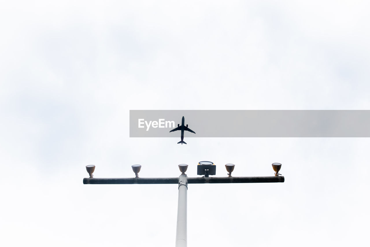 Low angle view of airplane flying in sky