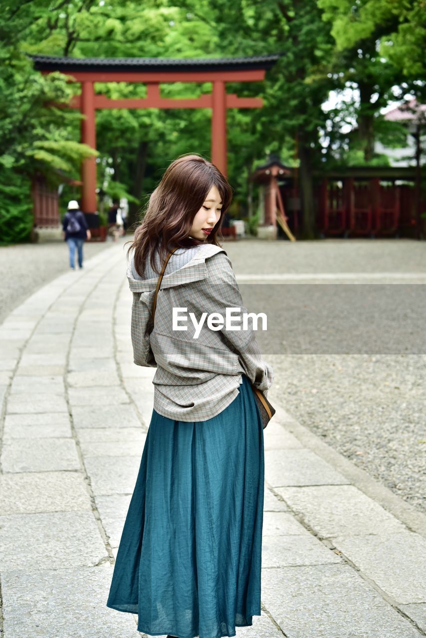 Woman standing on footpath