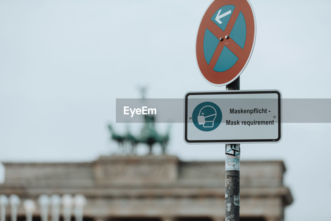 Road sign against sky