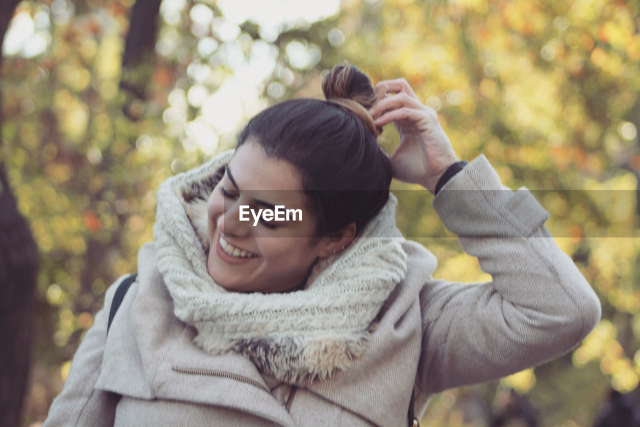 Beautiful smiling woman in park during winter