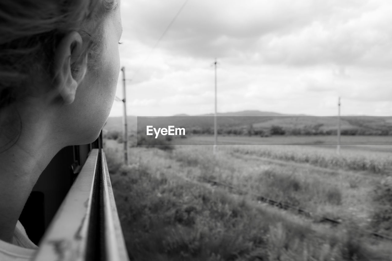 PORTRAIT OF MAN ON RAILROAD TRACK