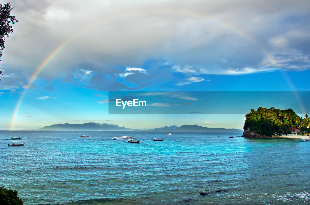 SCENIC VIEW OF SEA AGAINST RAINBOW