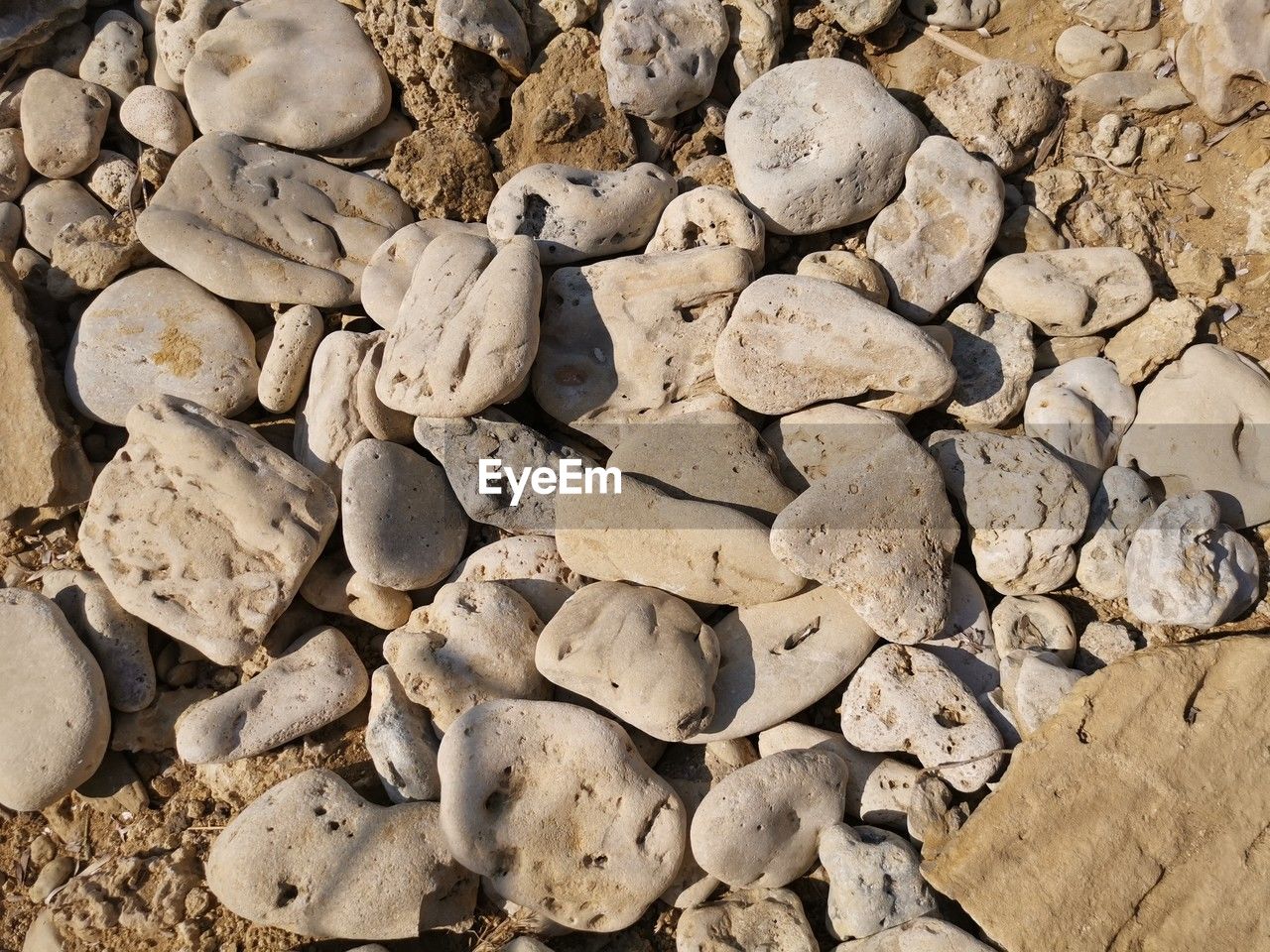 rock, soil, land, nature, sand, large group of objects, high angle view, no people, day, wood, full frame, abundance, geology, beach, backgrounds, sunlight, outdoors, pebble, stone, gravel, close-up