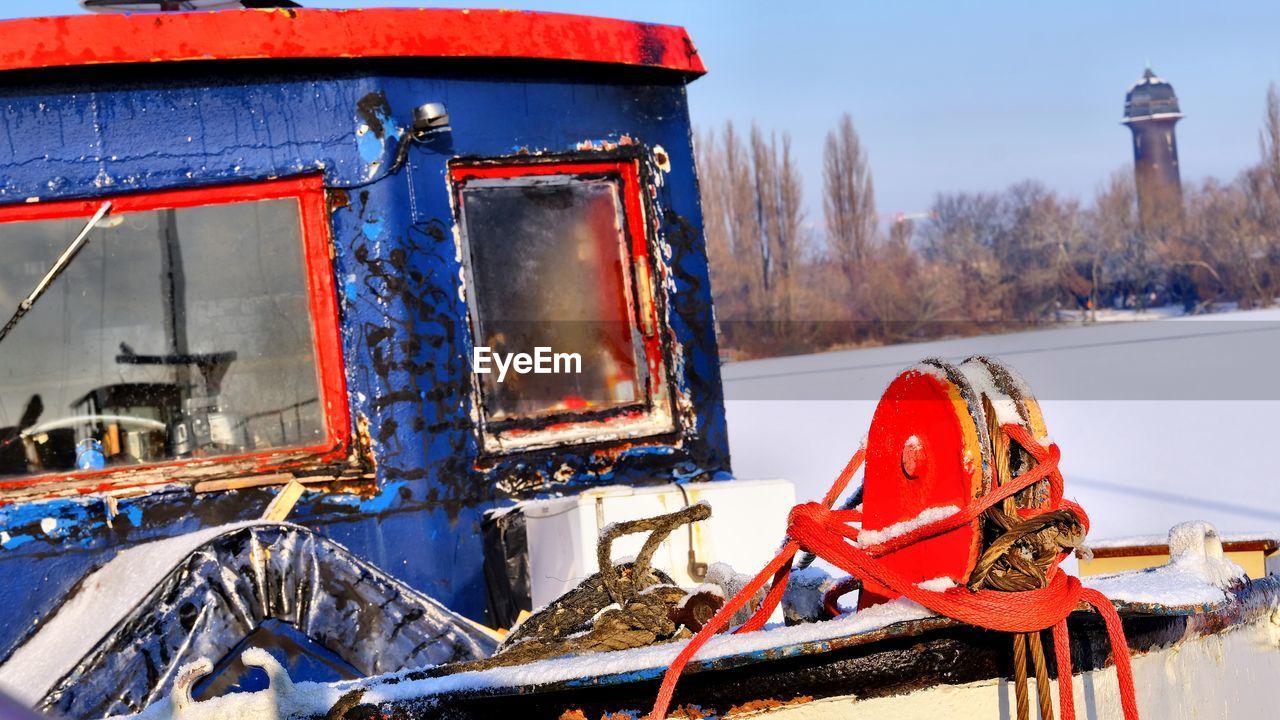 CLOSE-UP OF RED CAR ON SNOW COVERED TRUCK