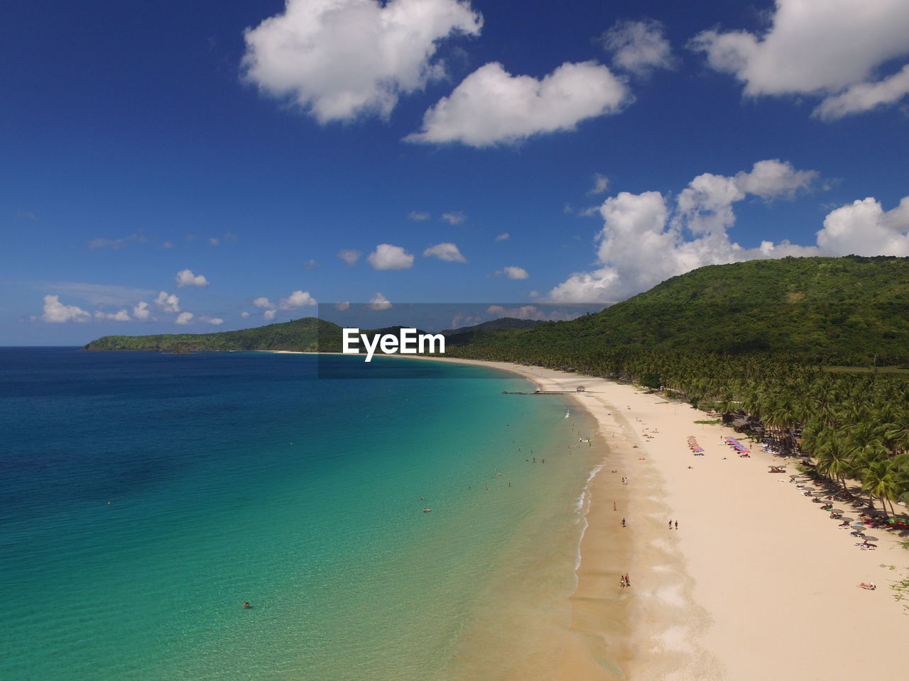 Scenic view of beach against blue sky