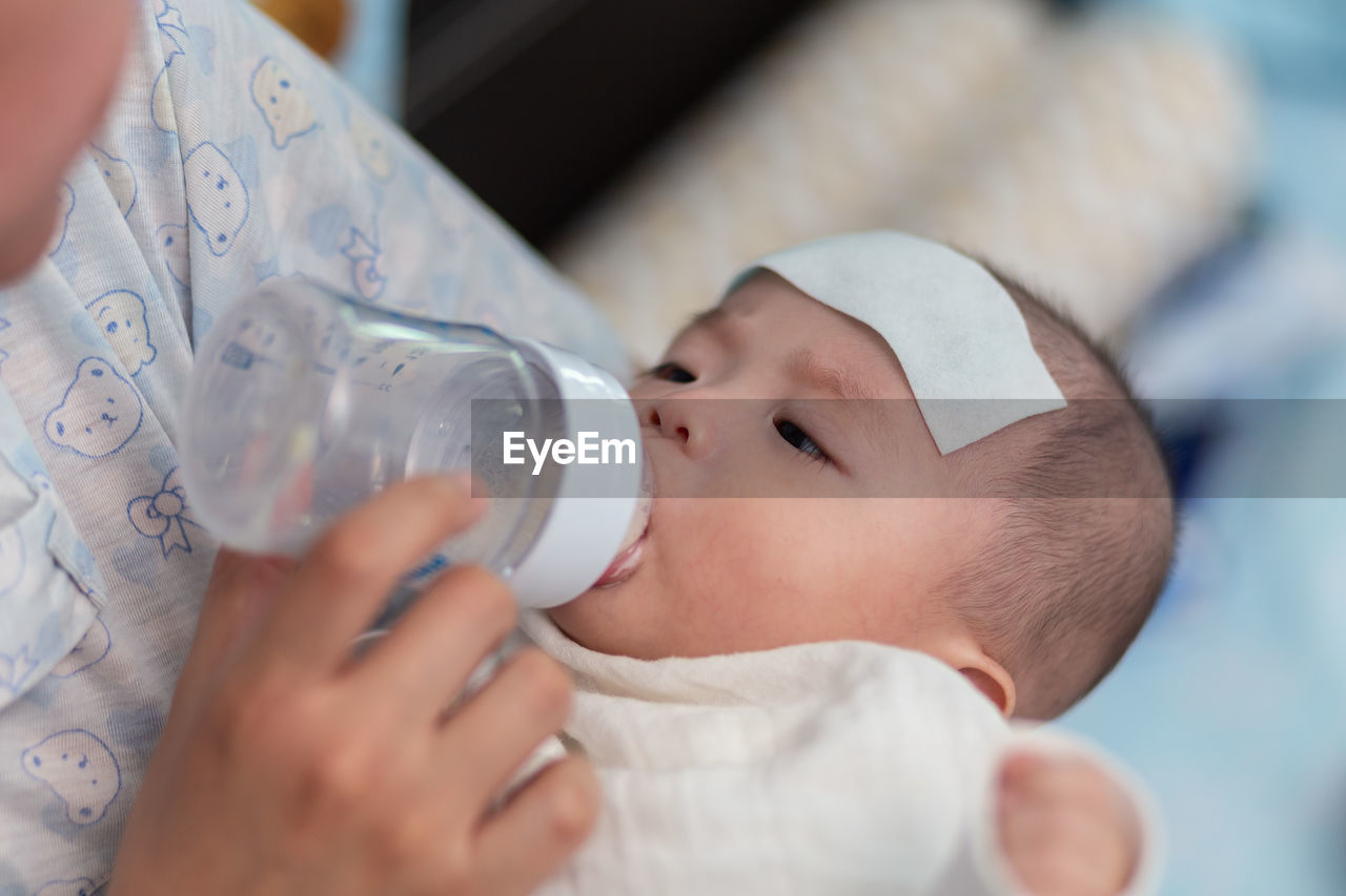 Mother feeding baby at home