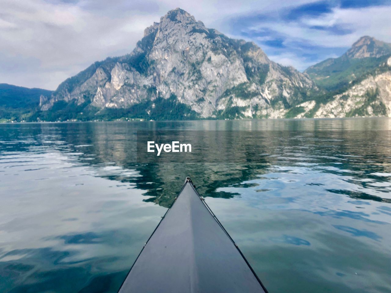 Scenic view of lake by snowcapped mountains against sky