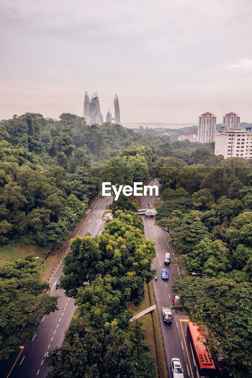High angle view of street amidst buildings against sky