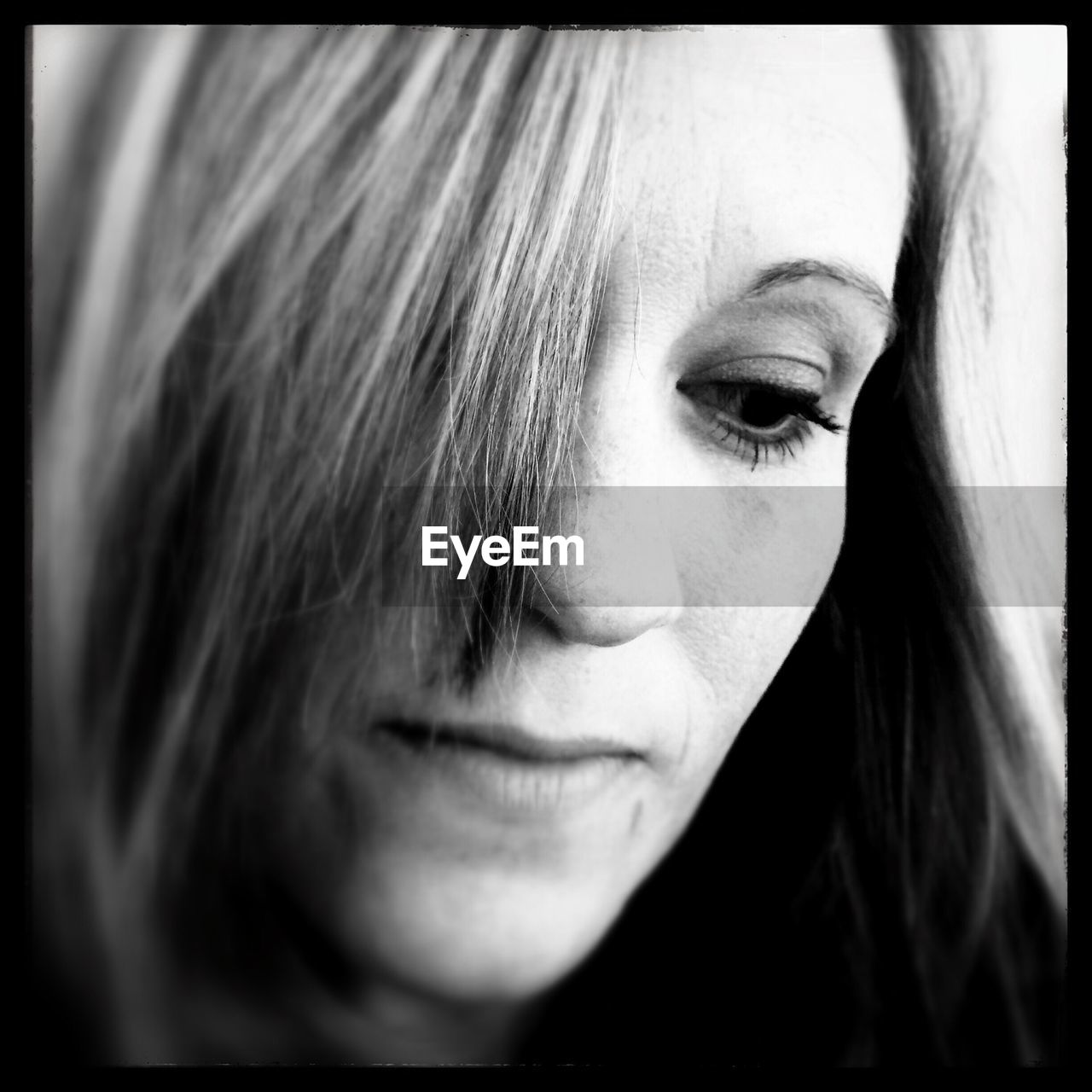 Close-up of thoughtful mid adult woman looking down