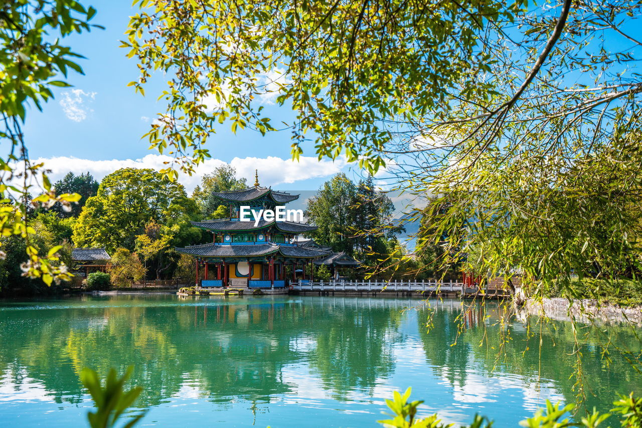 GAZEBO BY LAKE AGAINST SKY