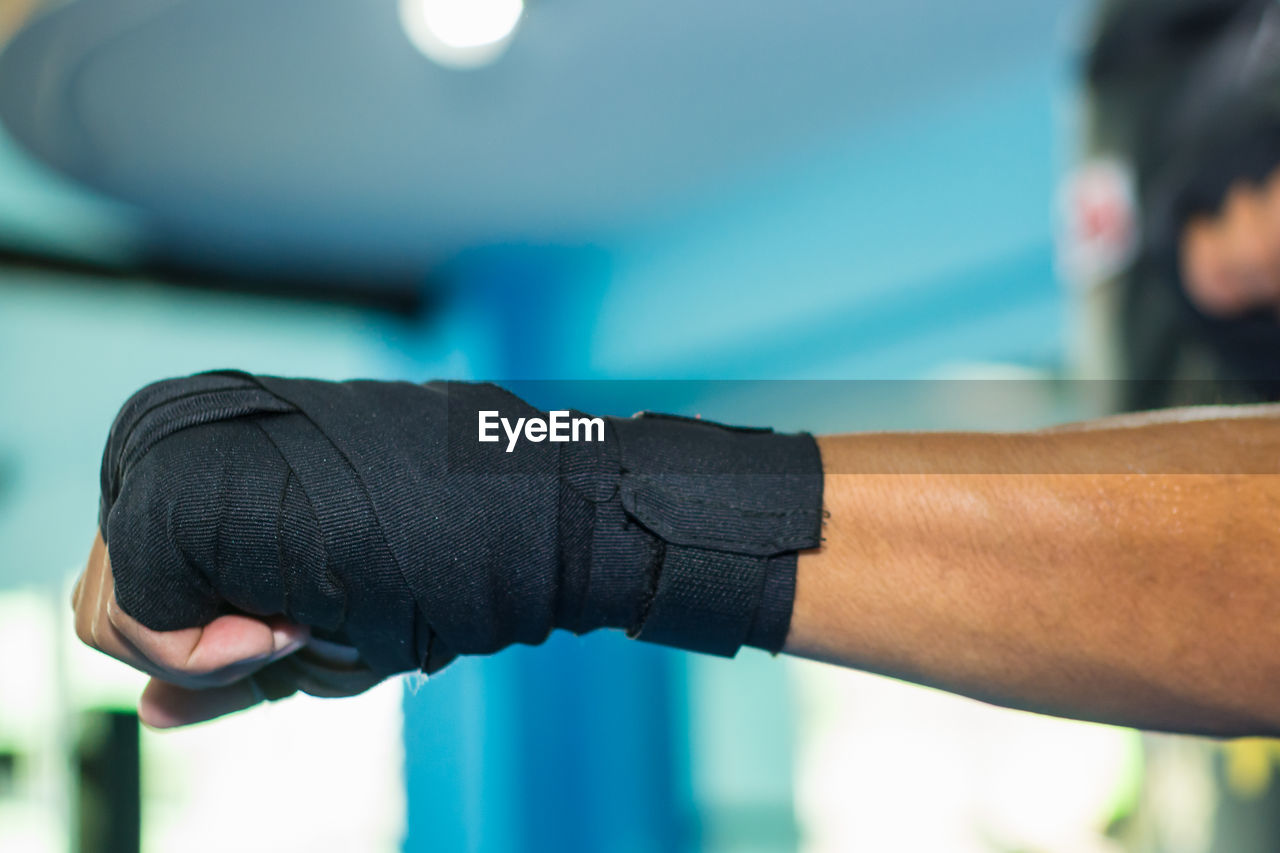 Cropped image of man wearing boxing glove