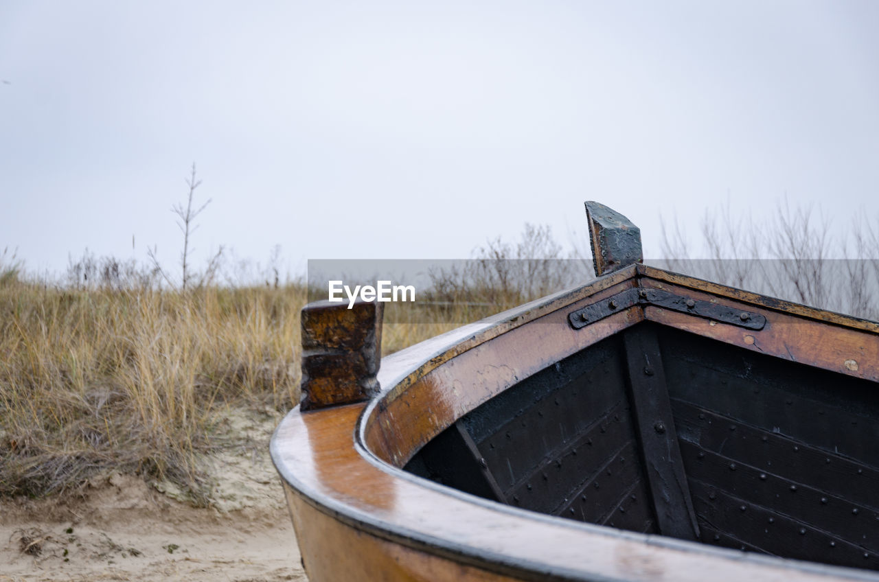 Empty boat at beach against clear sky