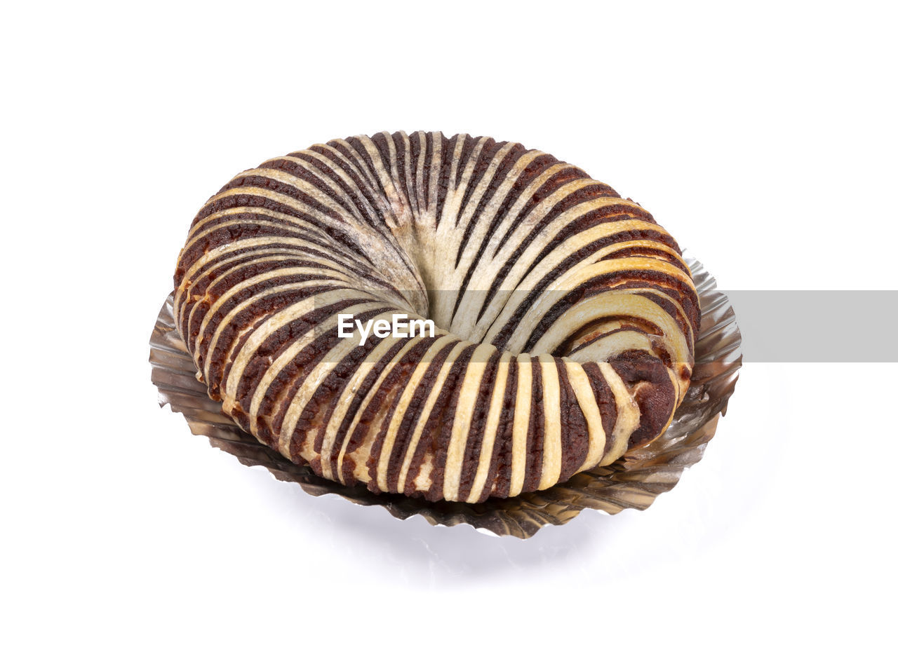 white background, brown, cut out, spiral, studio shot, food, food and drink, no people, indoors, sweet food, pattern, fossil, close-up, single object, shell, animal, sweet, animal shell, swirl