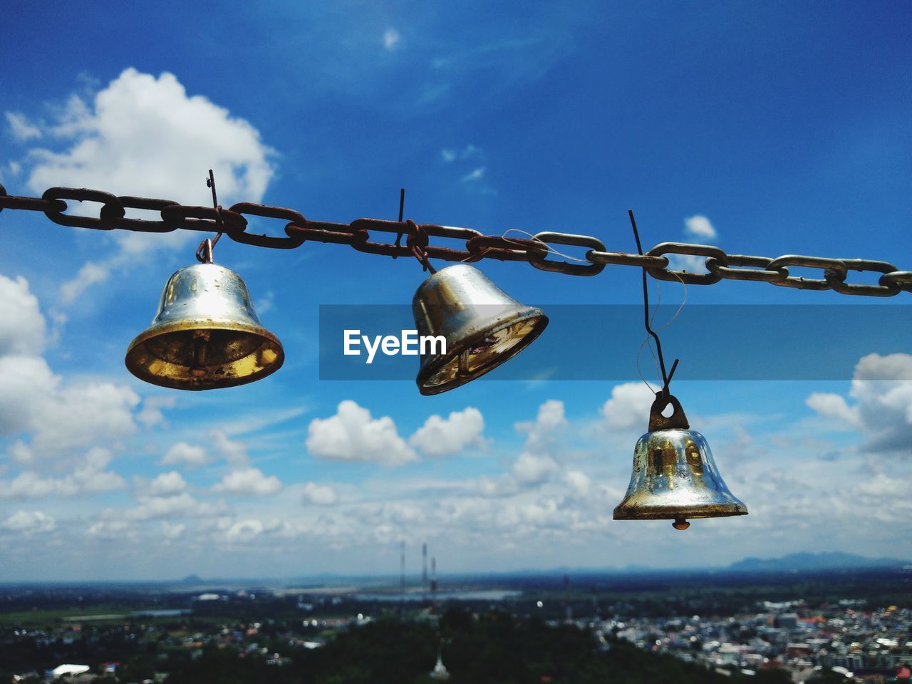 LOW ANGLE VIEW OF LIGHT BULB HANGING AGAINST SKY