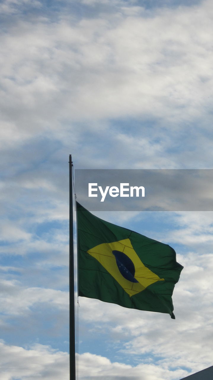 Low angle view of brazilian flag against sky