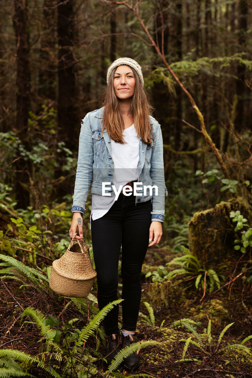 Beautiful woman forages in the rainforest near tofino