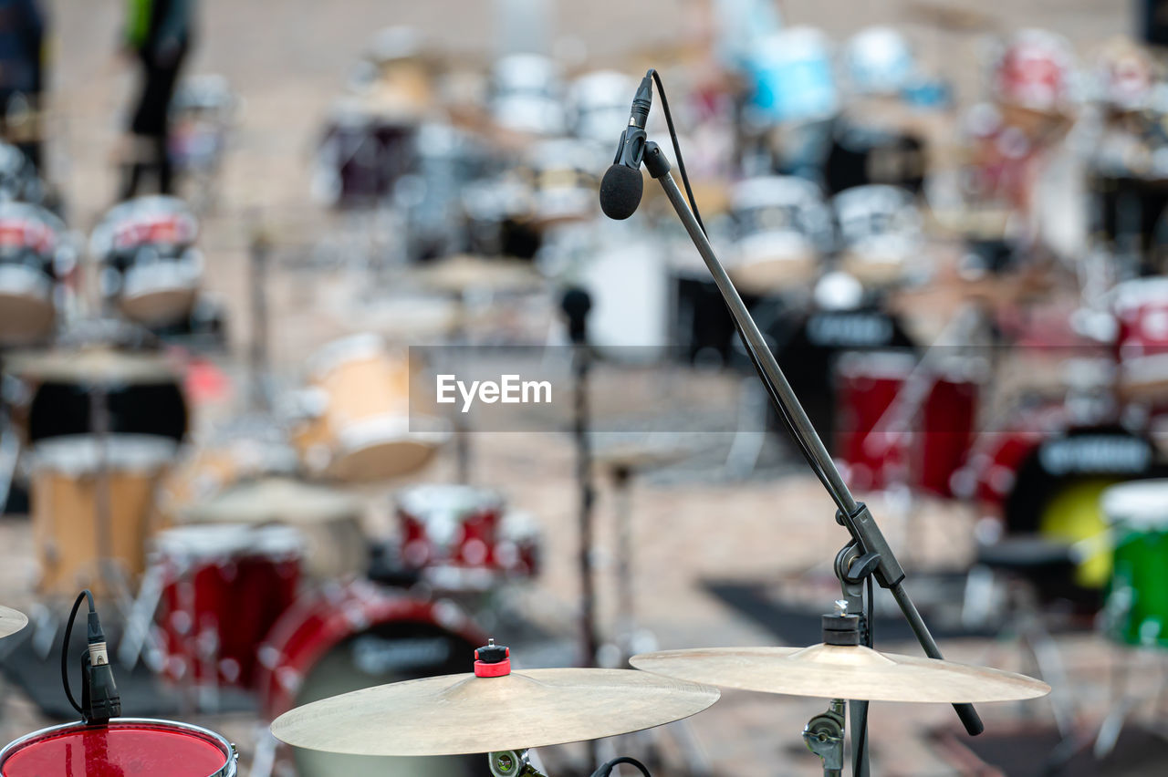 A set of plates in a drum set. at a concert of percussion music, selective focus, close-up