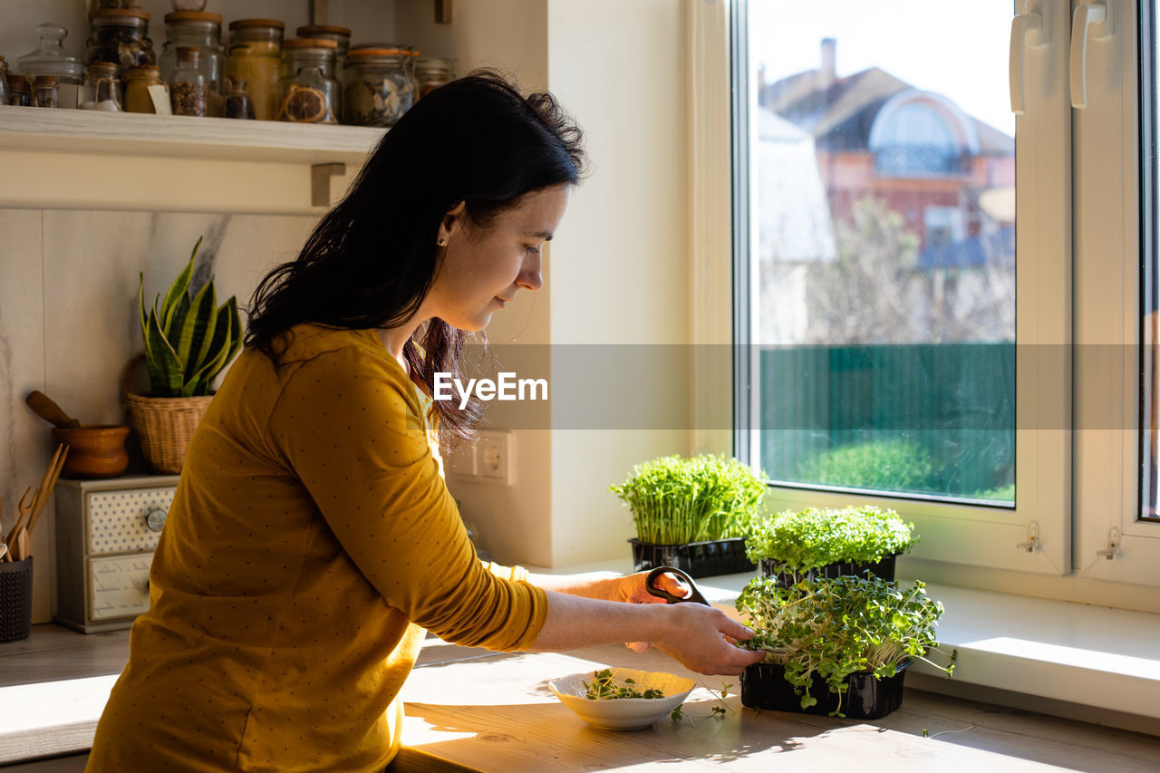 Woman looking at window at home