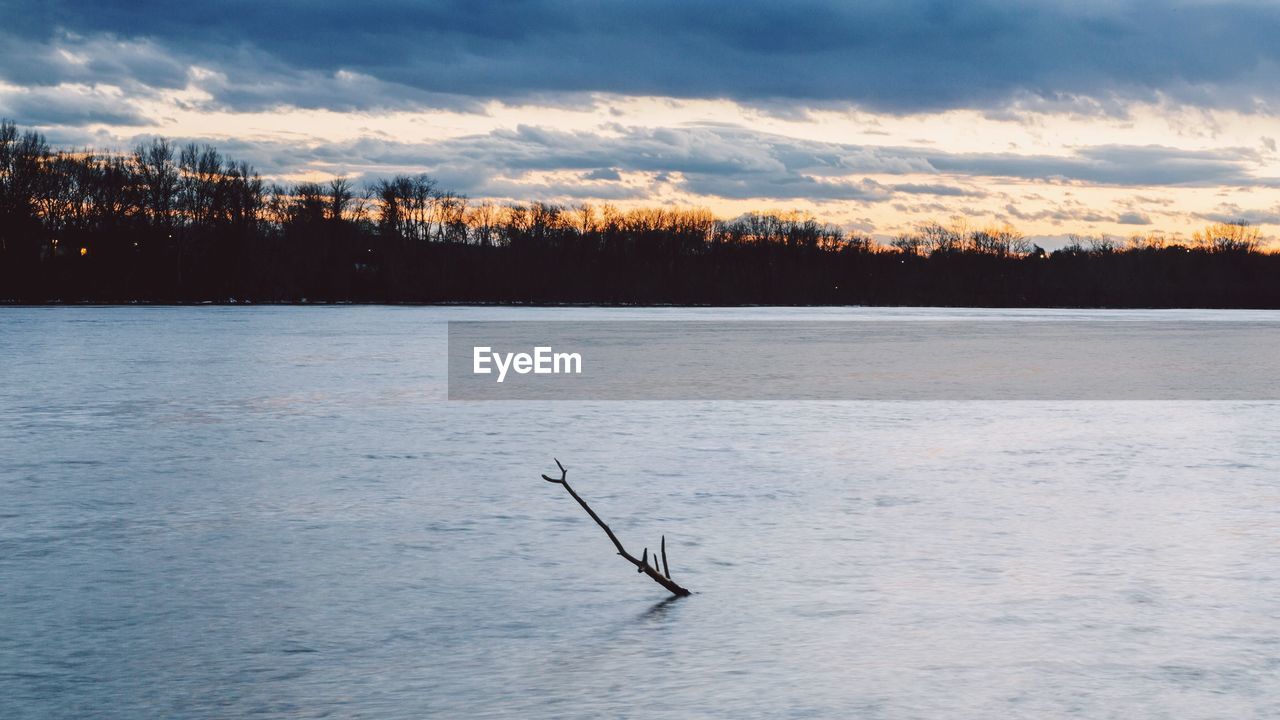 Scenic view of lake against sky during sunset