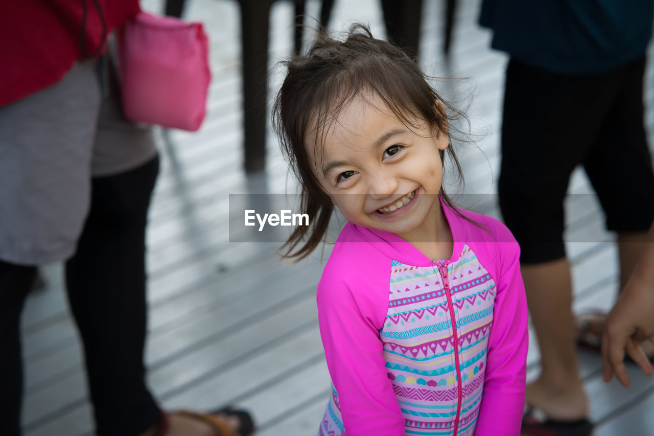 Portrait of cute girl smiling while standing outdoors