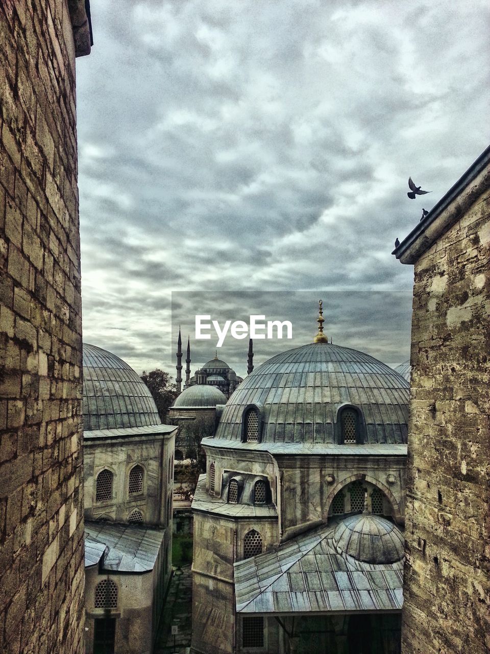 Mosque against cloudy sky