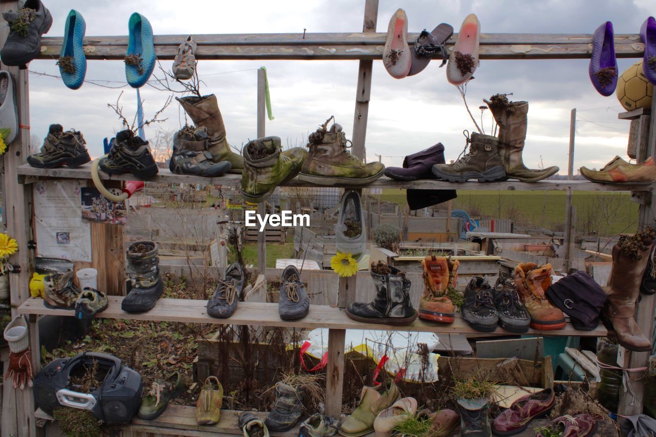 High angle view of old shoes on rack at field
