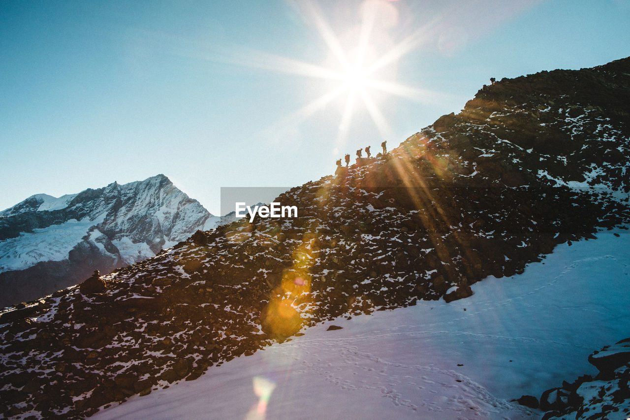 Sun shining over mountains during winter