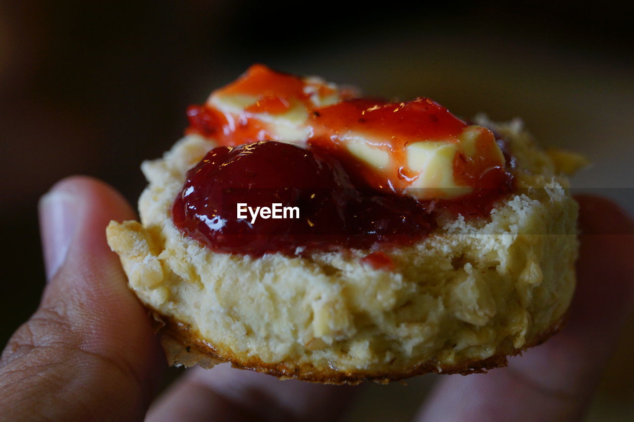 Cropped image of hand holding dessert