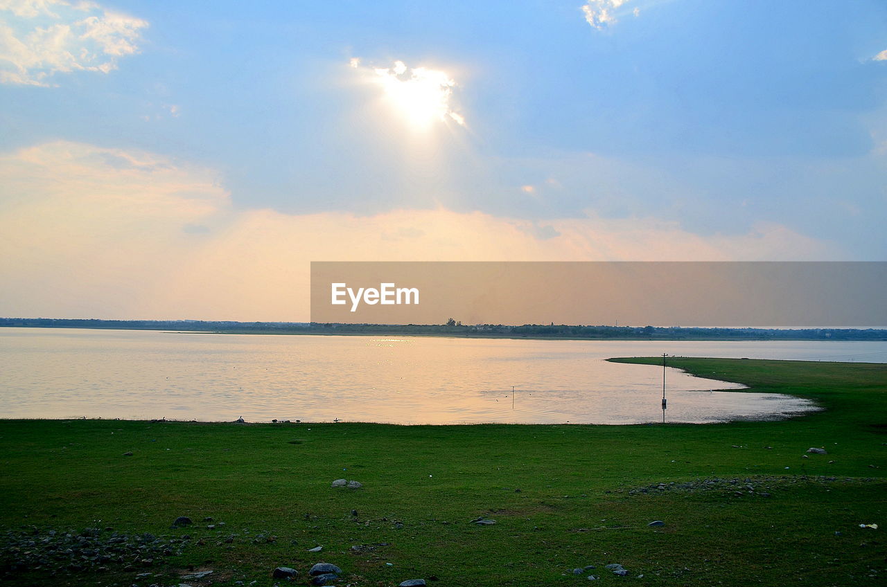 SCENIC VIEW OF SUNSET OVER SEA