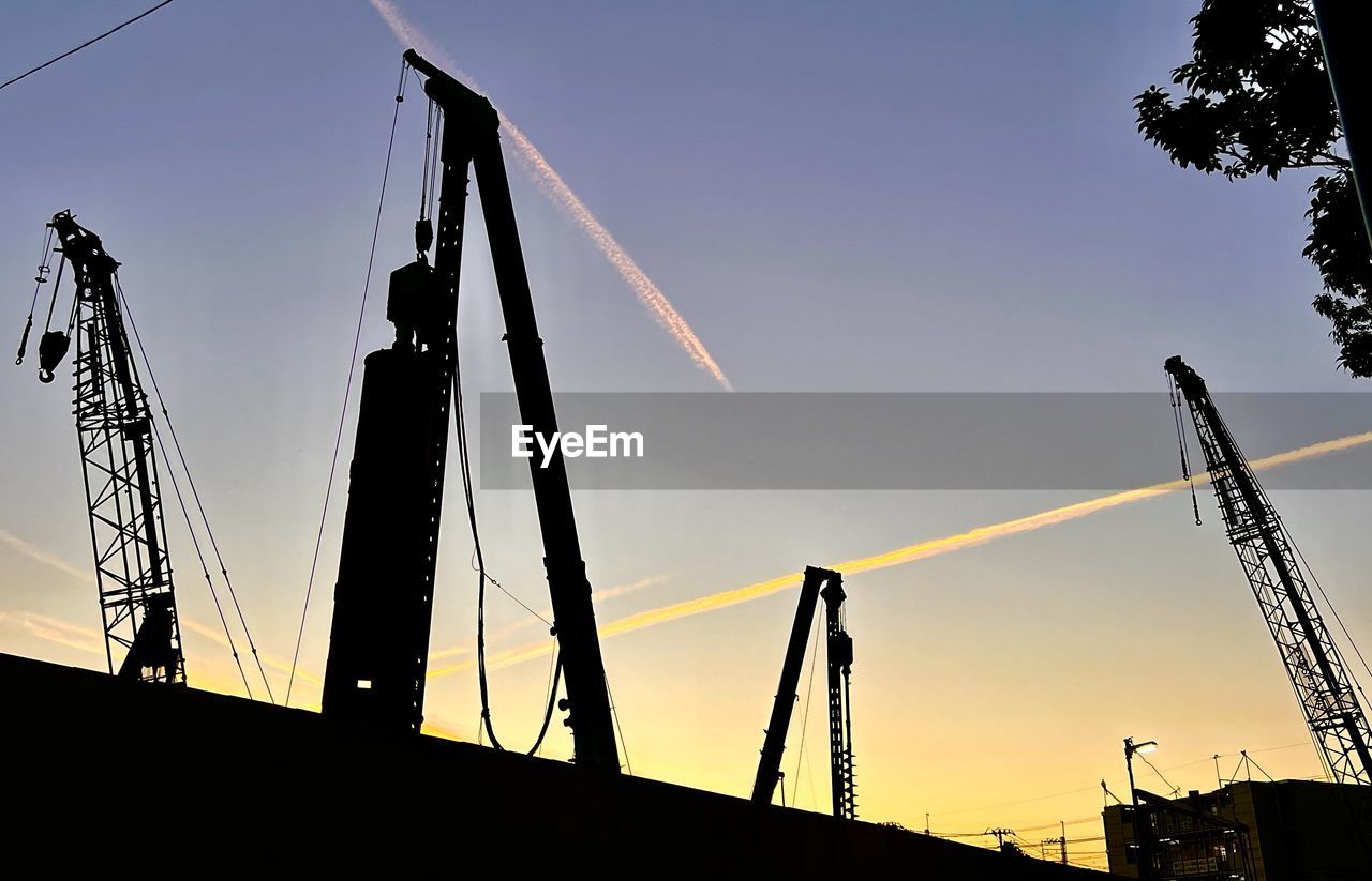 sky, silhouette, architecture, sunset, industry, nature, crane - construction machinery, built structure, transportation, machinery, business, no people, business finance and industry, electricity, low angle view, construction industry, outdoors, evening, back lit, water, dusk, mast