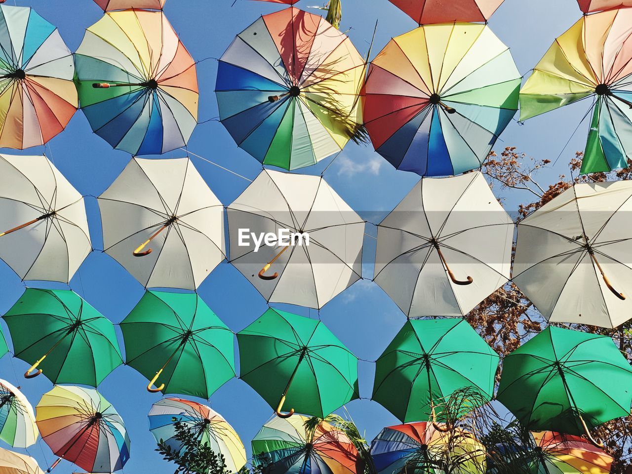 Low angle view of colorful umbrella against sky