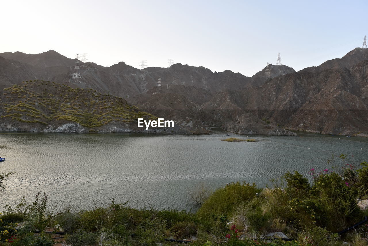 SCENIC VIEW OF LAKE AGAINST MOUNTAIN RANGE