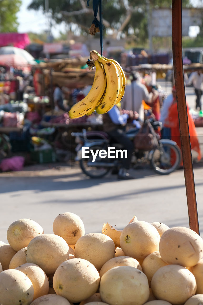 Banana and melon fruits for sale at market stall