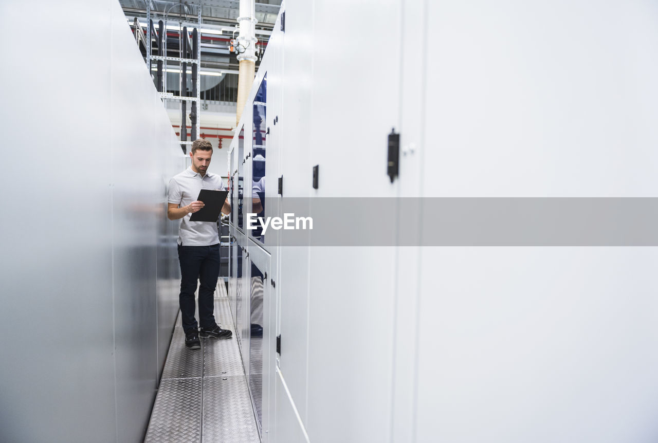 Man examining the system in factory