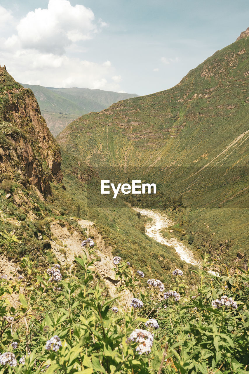 Scenic view of mountains against sky with a river in the midle