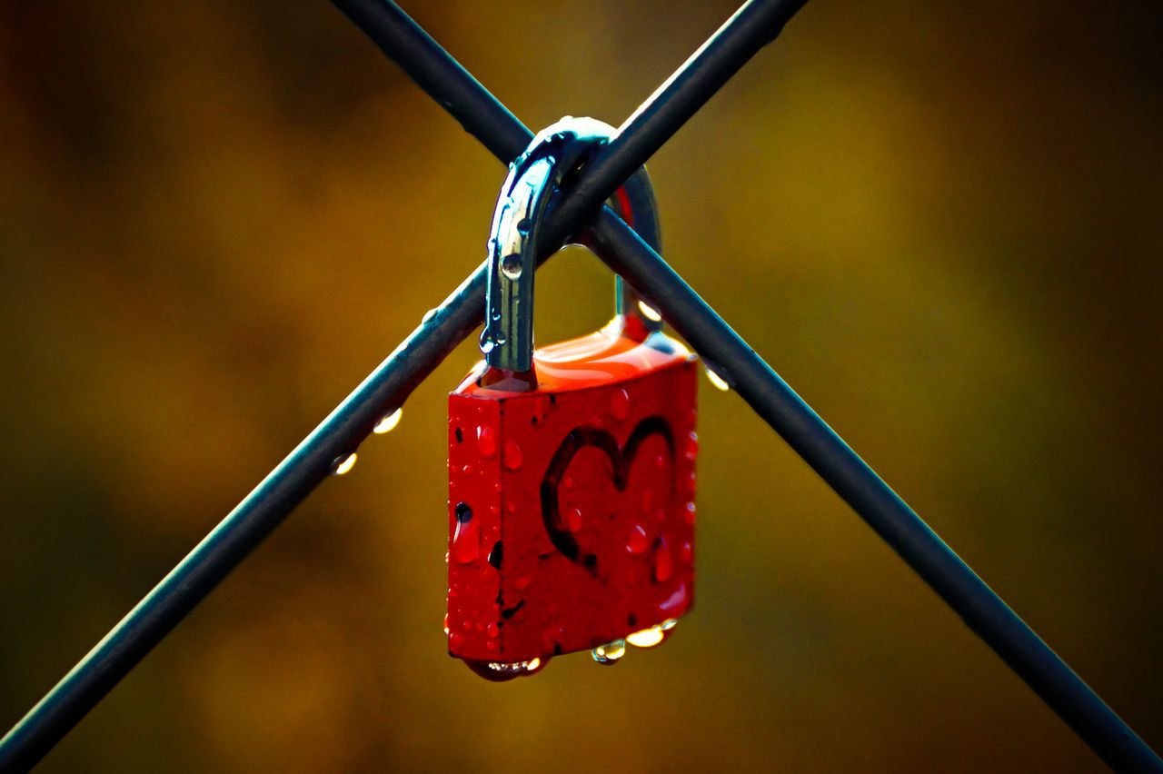 Close-up of love lock on metal fence