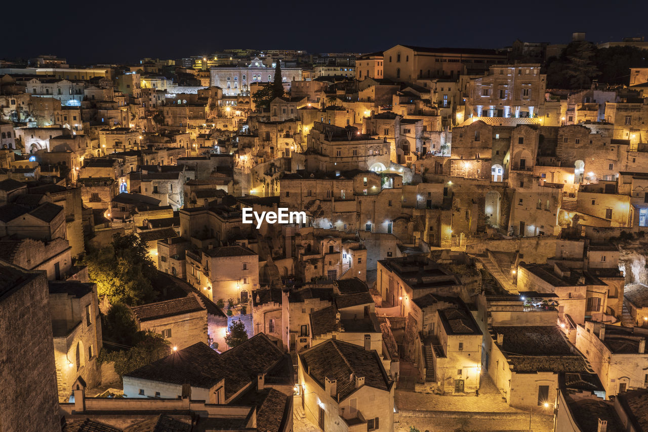 High angle view of illuminated buildings in city at night