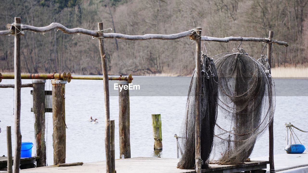 Close-up of wooden post in lake during winter