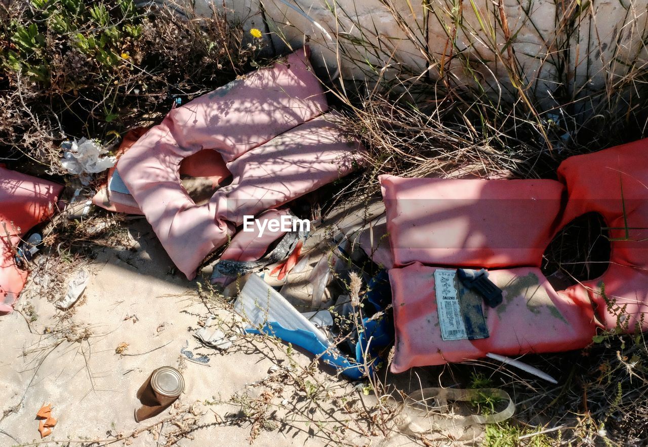 Abandoned life jackets by wall