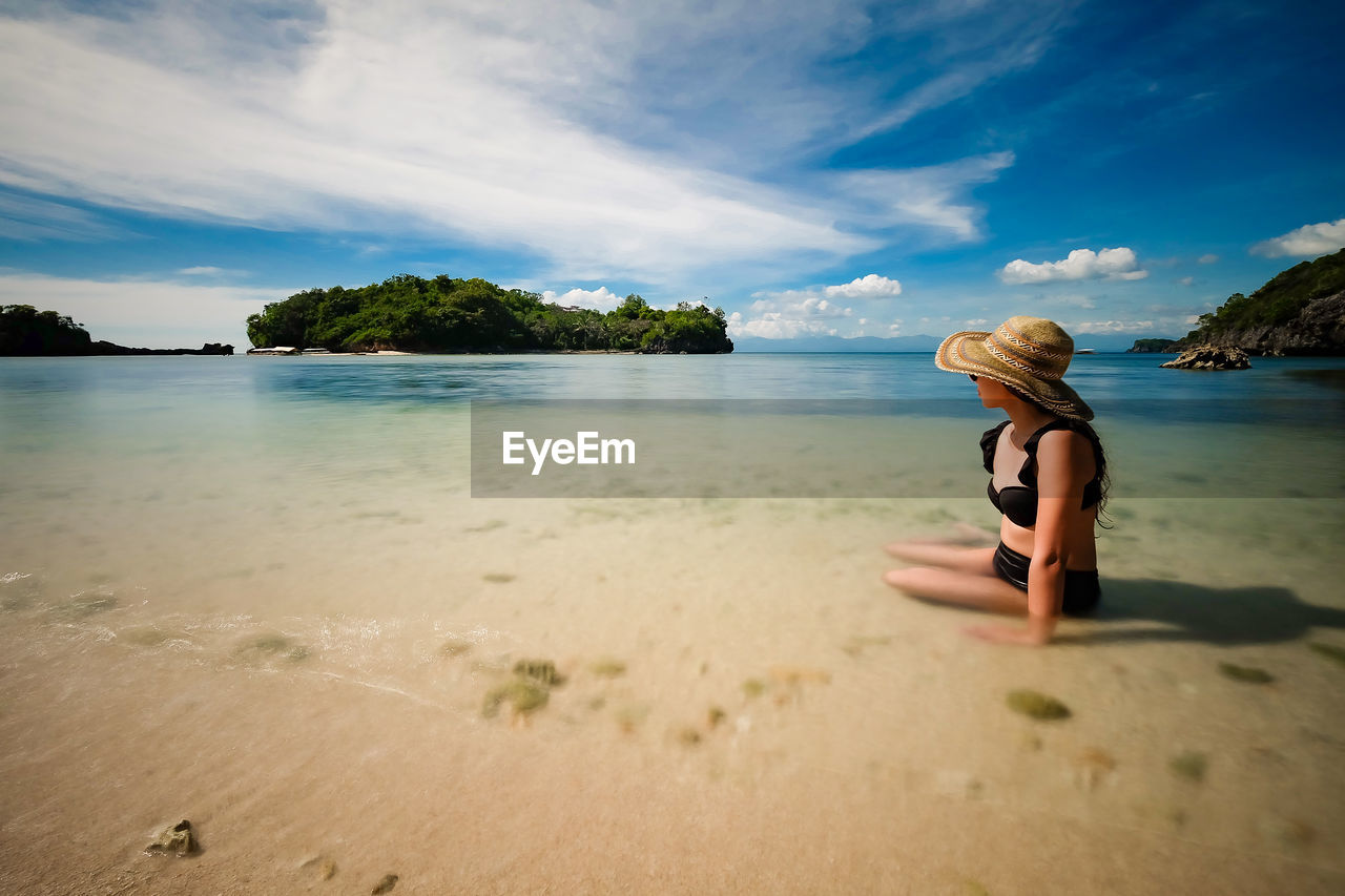 WOMAN ON BEACH WITH UMBRELLA