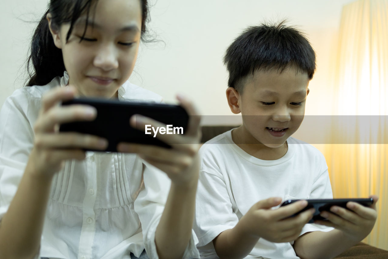 BOY USING MOBILE PHONE